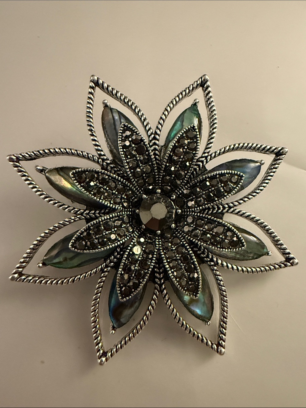 Silver-Tone Floral Brooch with Iridescent Green-Blue Petals